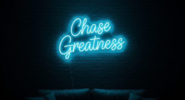 Chase Greatness neon sign in ice blue on brick wall