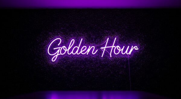 Golden Hour neon sign in purple on grass wall