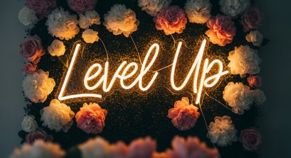 Level Up neon sign in yellow on flower wall
