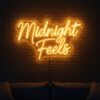 Midnight Feels neon sign in yellow on brick wall