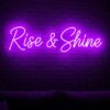 Rise & Shine neon sign in purple on brick wall