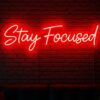 Stay Focused neon sign in red on brick wall