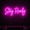 Stay Ready neon sign in pink on brick wall